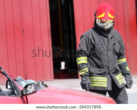 isolated Italian fireman with protective uniform and red helmet on his head