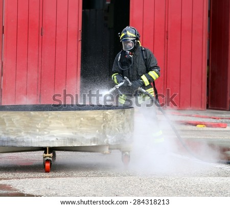 fireman with breathing apparatus and oxygen bottles during the exercise in firehouse
