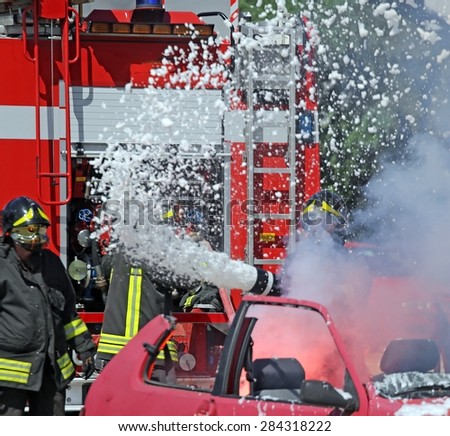Firefighters put out the fire with foam in the car