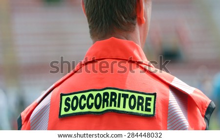 italian rescuer with orange uniform at stadium