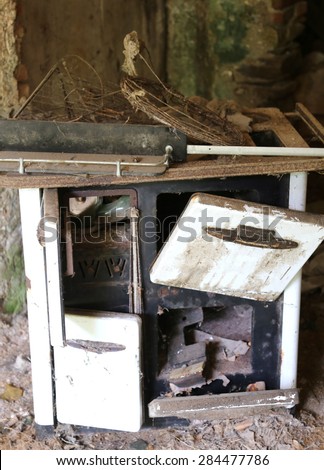 old wood-burning stove in an abandoned destroyed house