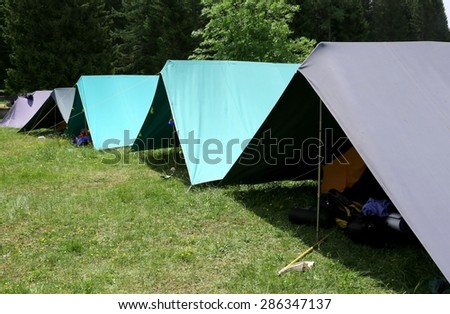 row of tents in the summer camp of the boyscout  in the mountains