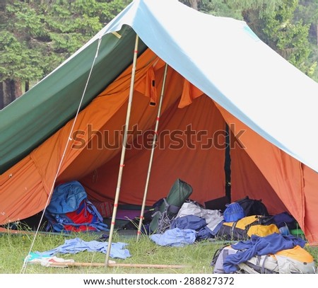 large tent of boy scout camp with backpacks and sleeping bags