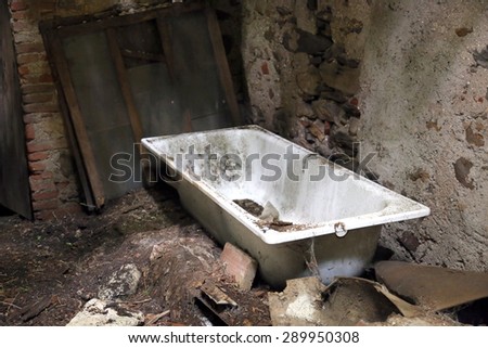 dirty old bathtub in unsafe House destroyed and abandoned