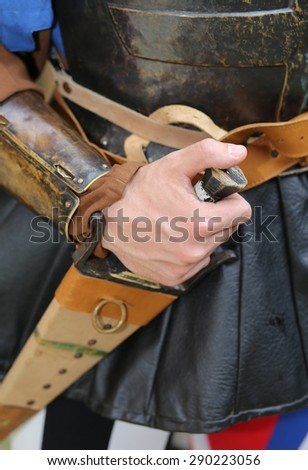 medieval soldier his hand on the knife during a combat reenactment of the middle ages