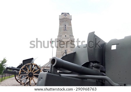 italian cannon of the first world war and the ossuary monument to dead soldiers at war