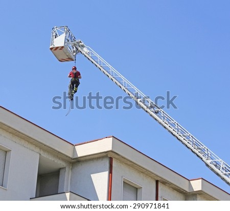 expert firefighter down with the rope in the building during a fire alarm in the firehouse