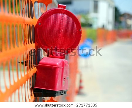 Road yard with red signal lamp on road excavation