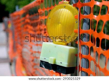 Road yard with yellow signal lamp on road excavation