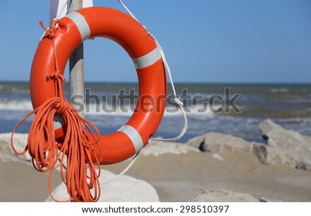 Orange jackets with rope to rescue swimmers in the sea in summer