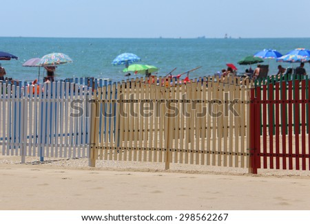 fence of a playground on the beach in summer