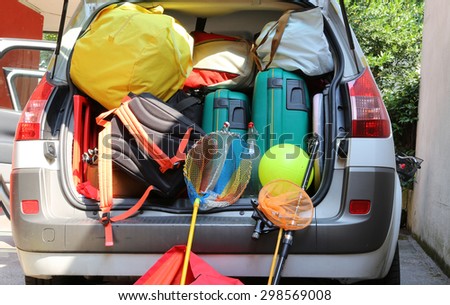luggage and suitcases in car for departure for summer holidays