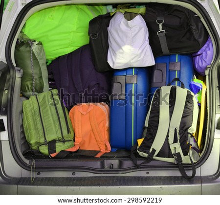 car overloaded with suitcases and duffle bag for family travel