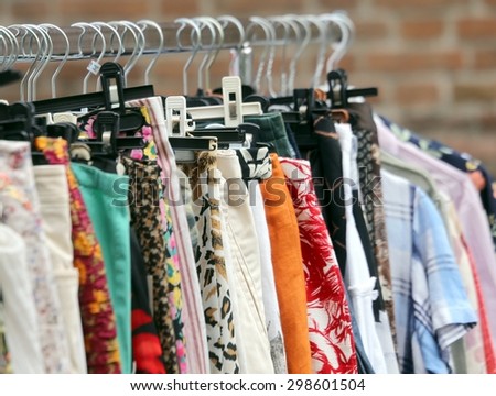 vintage clothes hanging in the flea market of used things