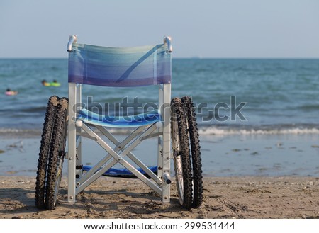 wheelchair to move around on the sand of the beach in summer
