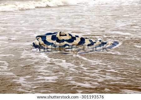Broken beach umbrella in the sea after the storm