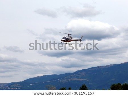 civil helicopter flies in the sky and carries tourists for sightseeing