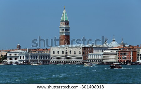 Venice, VE - Italy. 14th July, 2015:  Doge\'s Palace and the Bell Tower of St Mark and other palace with many boats and vaporetto ships on the adriatic sea