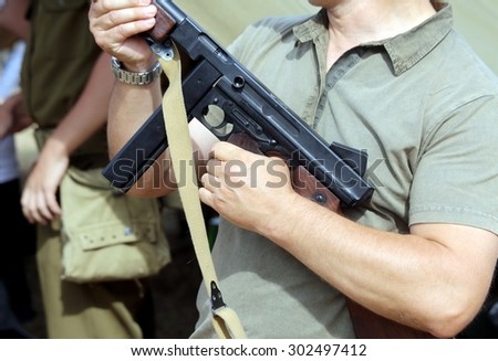 soldier in uniform with a submachine gun in his hand in training camp