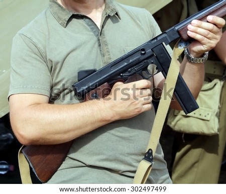 soldier in uniform with a gun in his hand during the battle