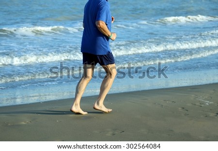 senior athlete runs on the Sea Beach to keep fit