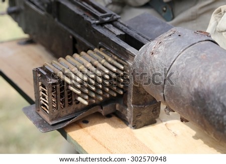 charger with many bullets of a machine gun during a military war exercise