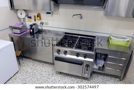industrial kitchen with big steel stove to cook lunches to many people