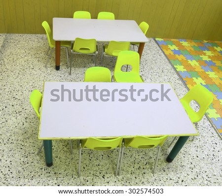 colorful school chairs and tables for children without people