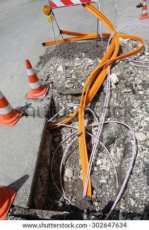 Road construction with pipes for laying optical fiber for high speed internet