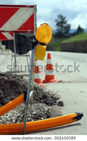 lamp in road construction for laying telecommunications infrastructure in optical fiber