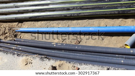 corrugated pipes and gas pipelines inside the excavation in road construction