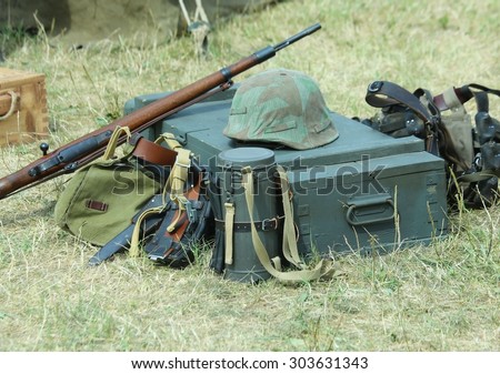 helmet of soldier uniform with a rifle in the army camp during a war exercise