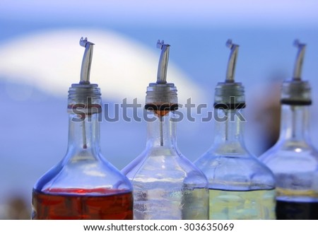 bottles of colored syrup for preparing ice creams in summer on the beach