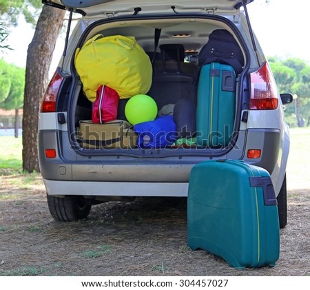 car and plenty of luggage and suitcases when leaving for family summer holidays
