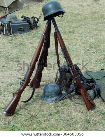three old war rifles and helmets of dead soldier at war