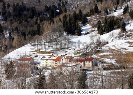 Lonely Mountain Village with snow-covered roofs in winter