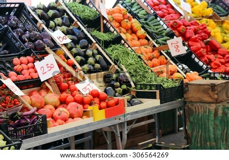 large fruit and vegetable stand with basket full of seasonal fruits in the local market of the city