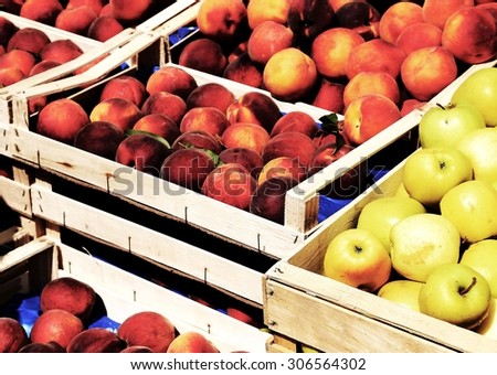 boxes of apples and peaches for sale at market fruit in summer