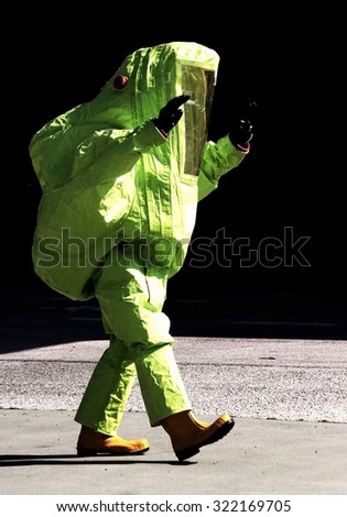 person with yellow protective suit to manage hazardous materials