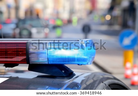 blue flashing police car during a roadblock to hunt down the escaped prisoners