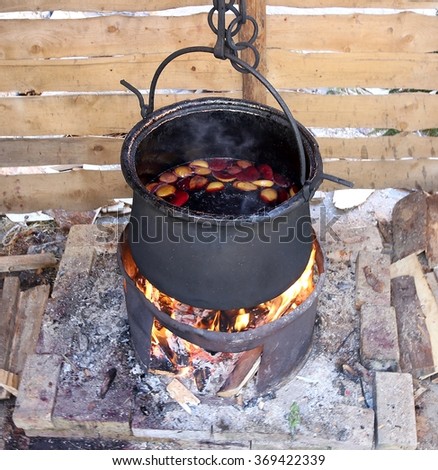 black pot to cook the mulled wine in the country festival in europe
