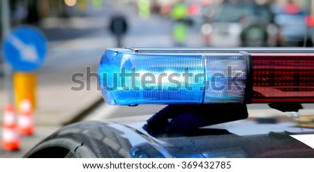 blue flashing police car during a roadblock to hunt down the escaped prisoners