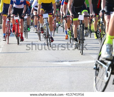 many racing bikes led by trained cyclists