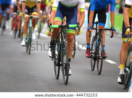 very fast cyclists pedal quickly through the streets of the city during the sporting event in europe