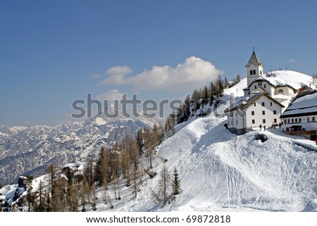 typical mountain village lost in the middle of the blanket of white snow on a cold winter day