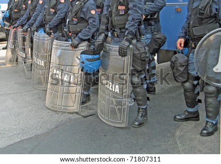 shields of the police on the street in riot gear to quell the unrest