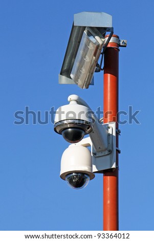 two security cameras for the safety of citizens and lamp