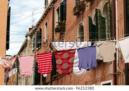 clothes hanging out to dry on a canal in Venice