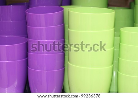 violets and green plastic pots stacked on sale at the market