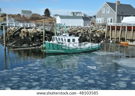 Fishing boat docked in an ice filled harbor at Biddeford Pool, Maine